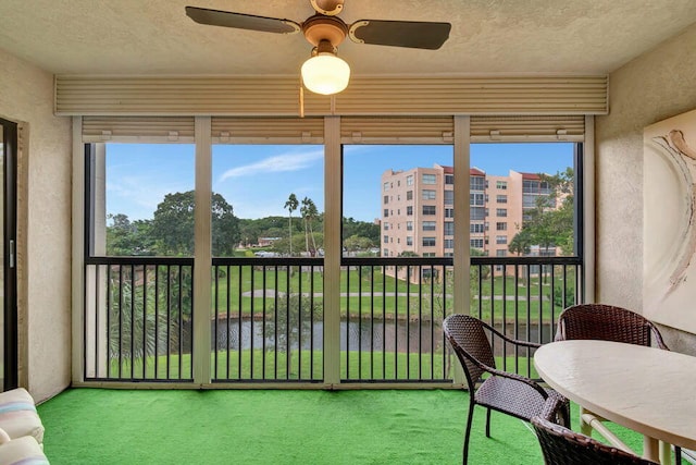 sunroom / solarium featuring ceiling fan and a healthy amount of sunlight