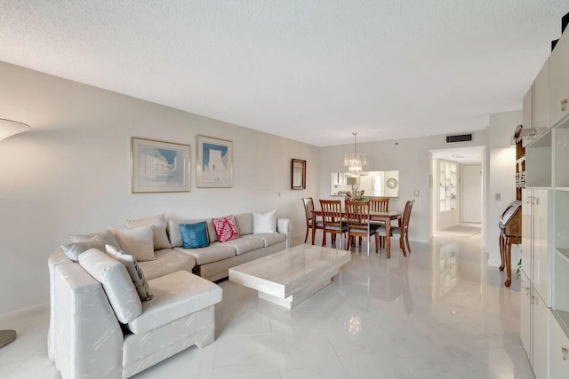 living room with a textured ceiling and a chandelier