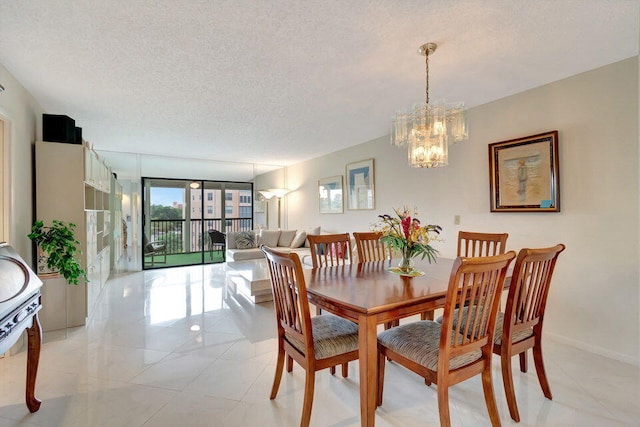 dining space with a chandelier and a textured ceiling