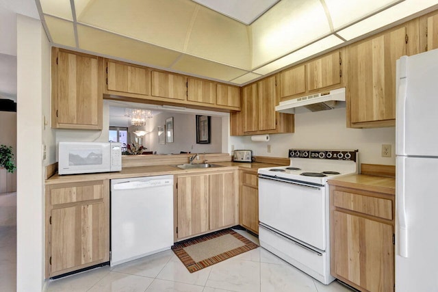 kitchen with light brown cabinetry, sink, white appliances, and a notable chandelier