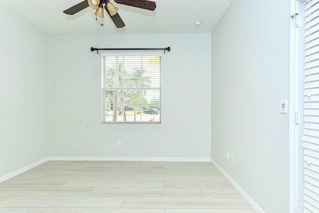 empty room with light hardwood / wood-style flooring and ceiling fan