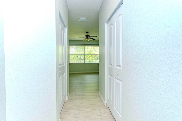 hall with light hardwood / wood-style flooring