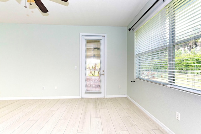 empty room with ceiling fan and light wood-type flooring