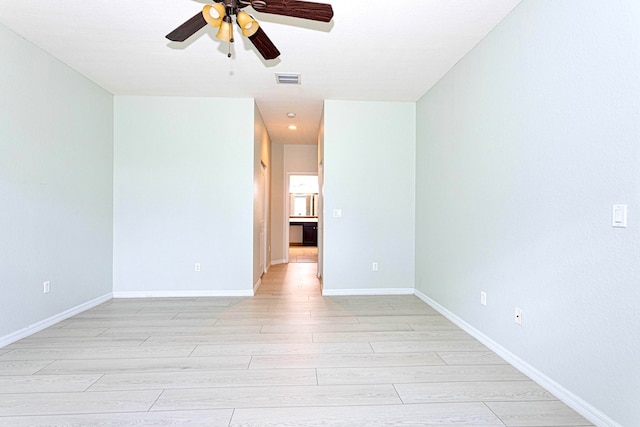 unfurnished room featuring light hardwood / wood-style floors and ceiling fan