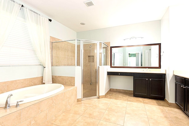 bathroom featuring vanity, independent shower and bath, and tile patterned flooring