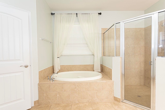 bathroom with tile patterned flooring and separate shower and tub