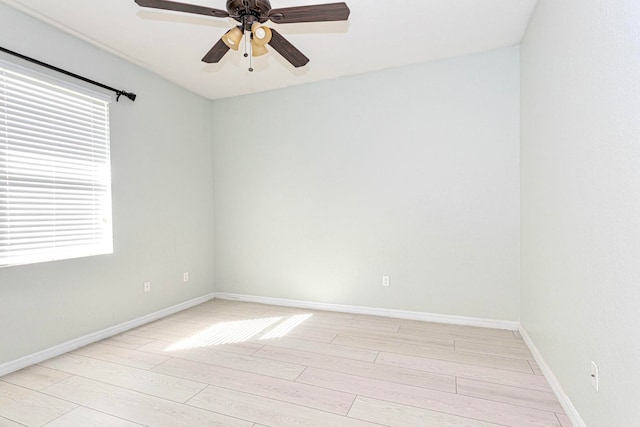 spare room with light hardwood / wood-style flooring, ceiling fan, and plenty of natural light