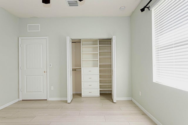 interior space with a closet, light wood-type flooring, and ceiling fan