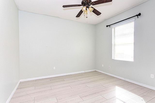 empty room with ceiling fan and light wood-type flooring