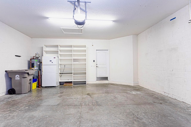 garage featuring a garage door opener, water heater, and white fridge