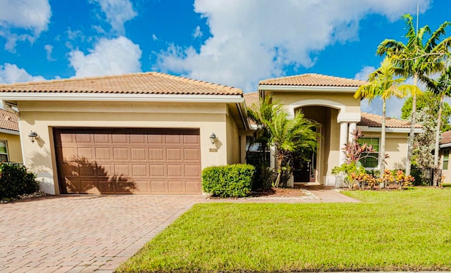 mediterranean / spanish-style house featuring a front lawn and a garage