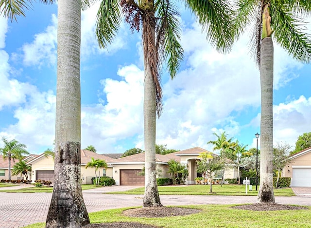 view of front of home with a front yard and a garage