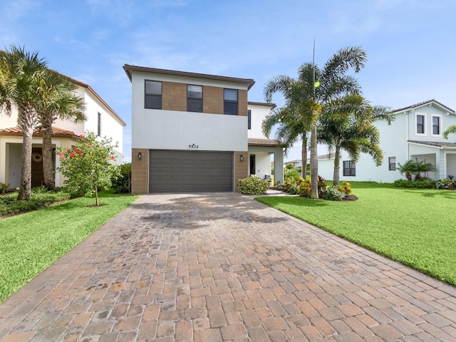 view of front of house featuring a front lawn and a garage