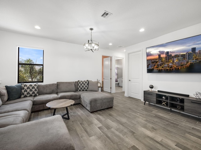 living room with hardwood / wood-style floors and a chandelier