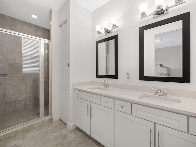 bathroom featuring a shower with door, vanity, and tile patterned flooring