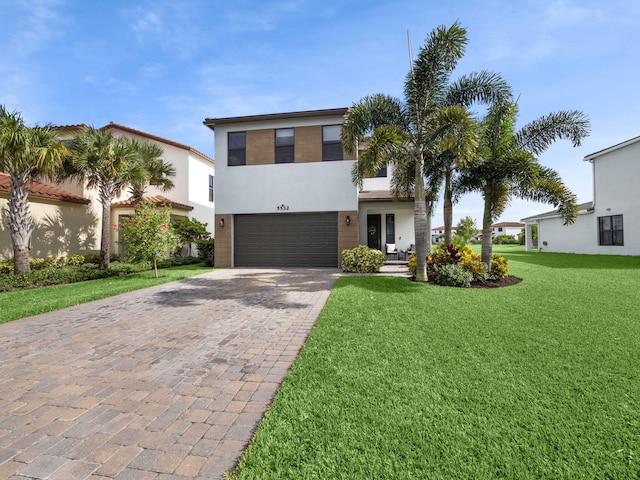 view of front of property with a front yard and a garage