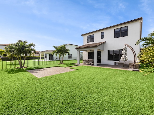 back of house featuring a patio and a yard