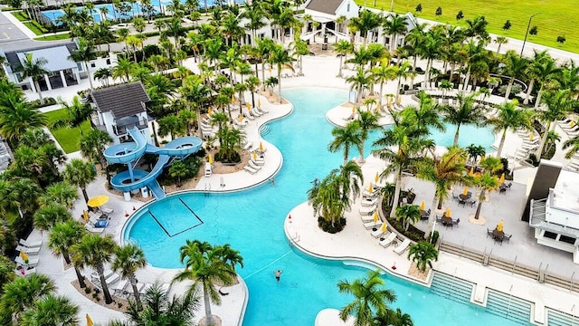 view of swimming pool with a water slide and a patio area