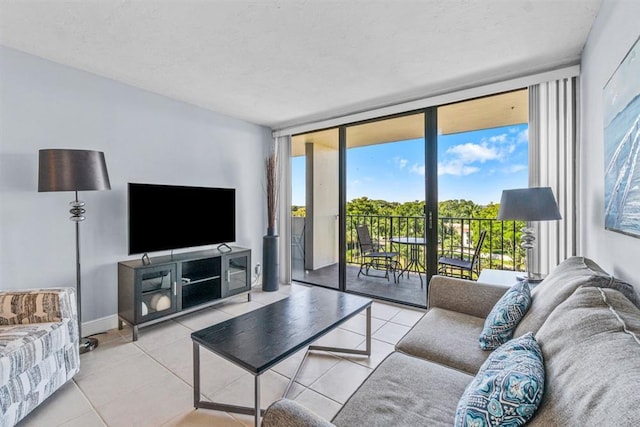 tiled living room with a textured ceiling and floor to ceiling windows