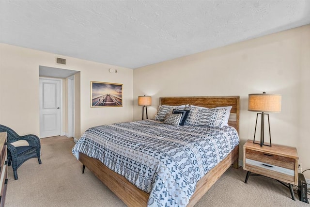 carpeted bedroom featuring a textured ceiling