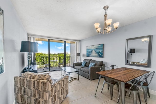 living room featuring a textured ceiling, expansive windows, light tile patterned floors, and an inviting chandelier