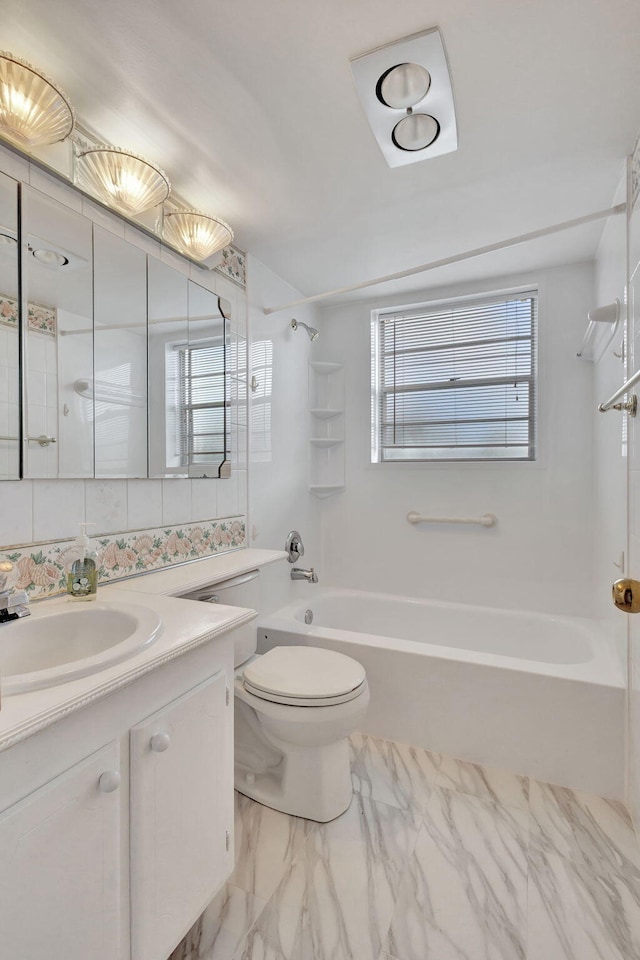 full bathroom featuring toilet, tiled shower / bath combo, and vanity