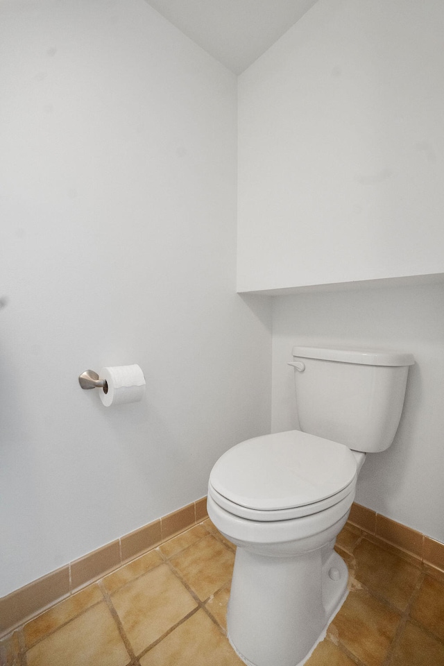 bathroom with tile patterned flooring and toilet