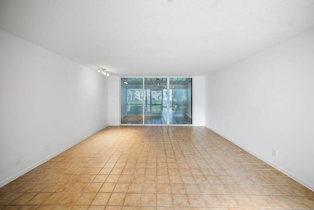 unfurnished room with light tile patterned floors