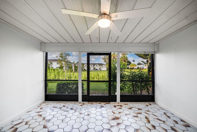 unfurnished sunroom with ceiling fan and wood ceiling