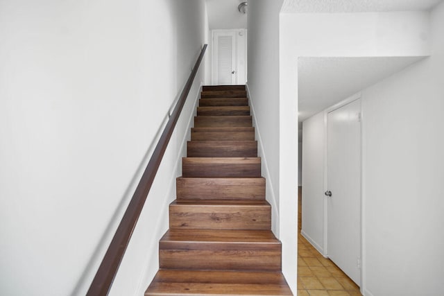 stairs with tile patterned floors