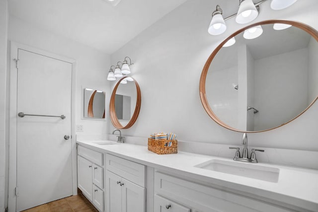 bathroom featuring tile patterned floors, vanity, and lofted ceiling