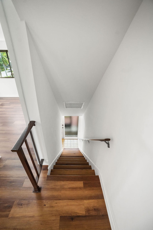 stairway with hardwood / wood-style floors