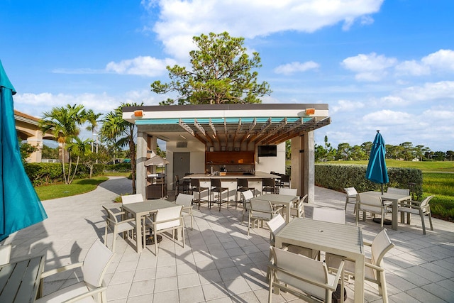 view of patio with an outdoor bar