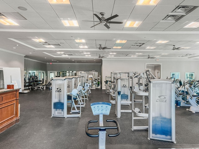 exercise room featuring a drop ceiling and ornamental molding