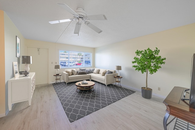 living room featuring ceiling fan and light wood-type flooring