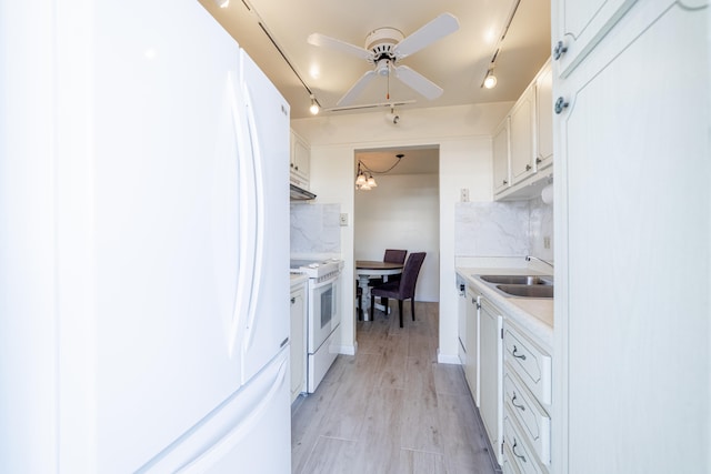 kitchen featuring ceiling fan, tasteful backsplash, track lighting, white appliances, and white cabinets