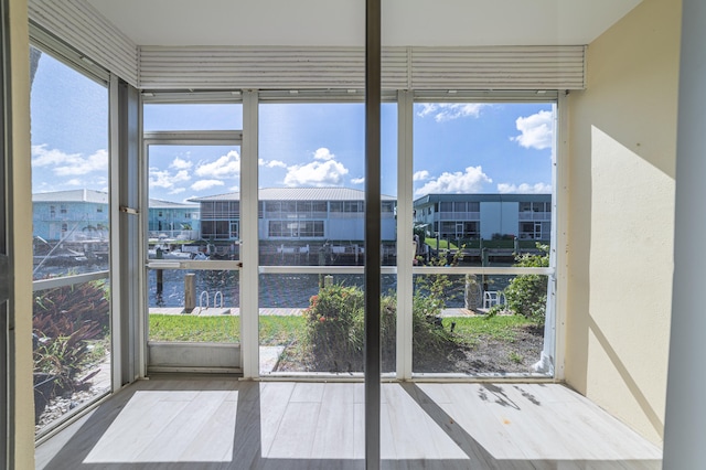 unfurnished sunroom with a water view