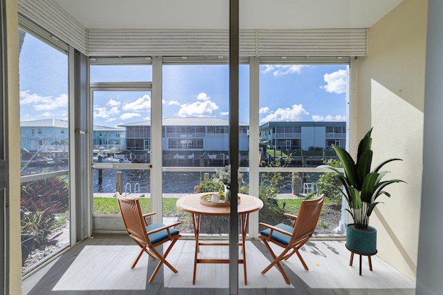 sunroom / solarium with a water view