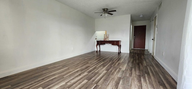 unfurnished room with ceiling fan, a textured ceiling, and dark hardwood / wood-style floors