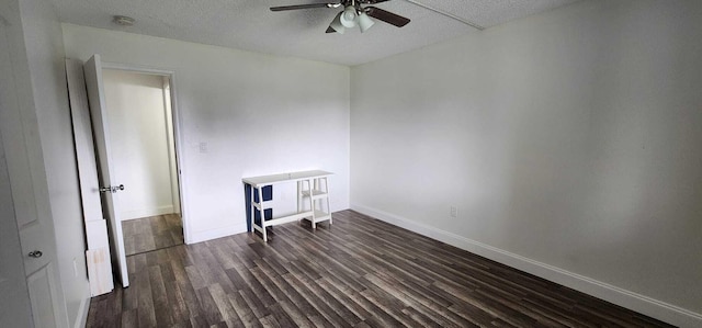 spare room with dark hardwood / wood-style floors and ceiling fan