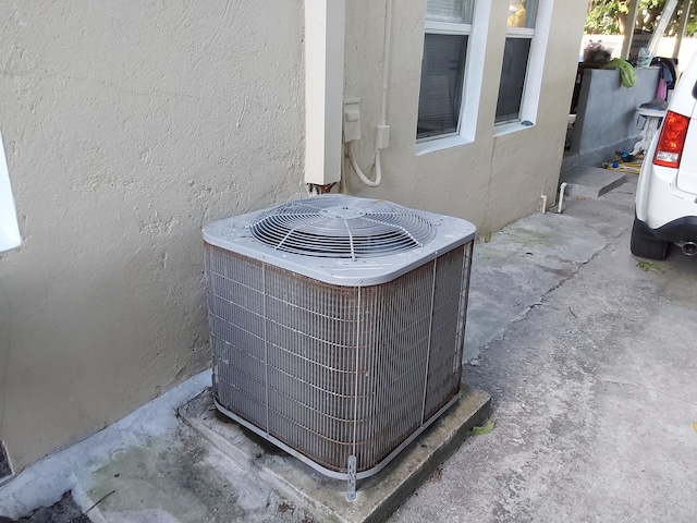 exterior details featuring cooling unit and concrete flooring