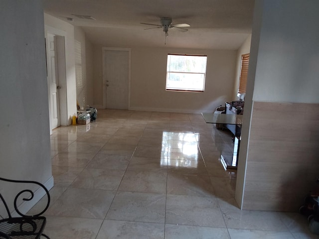 spare room featuring light tile patterned flooring and ceiling fan