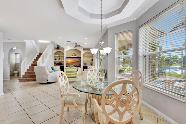 8951 Alexandra Cir, Wellington, FL 33414 - dining space with ornamental molding, light tile patterned flooring, a chandelier, baseboards, and stairway