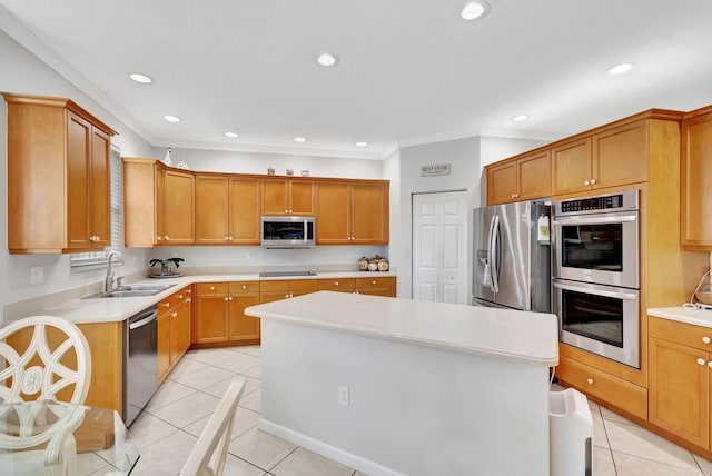 kitchen with light tile patterned floors, appliances with stainless steel finishes, ornamental molding, sink, and a center island