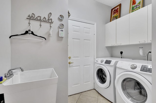 8951 Alexandra Cir, Wellington, FL 33414 - laundry area with cabinet space, washing machine and clothes dryer, and light tile patterned floors