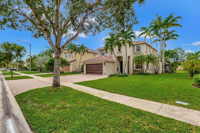 mediterranean / spanish-style house featuring a front lawn and a garage