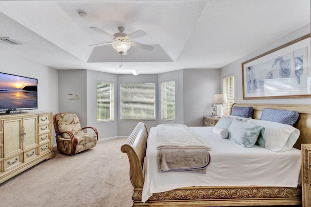 carpeted bedroom featuring ceiling fan and a textured ceiling