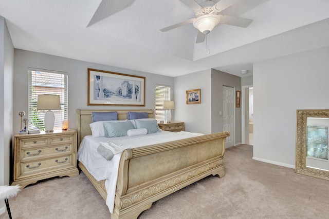 bedroom featuring ensuite bath, light colored carpet, a closet, and ceiling fan