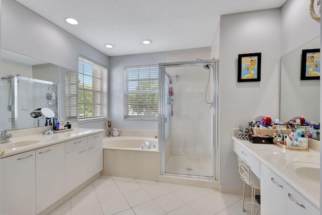 8951 Alexandra Cir, Wellington, FL 33414 - bathroom with a shower stall, a bath, two vanities, recessed lighting, and a textured ceiling