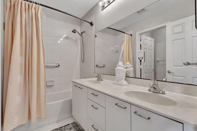 8951 Alexandra Cir, Wellington, FL 33414 - bathroom featuring tile patterned floors, shower / tub combo with curtain, double vanity, and a textured ceiling